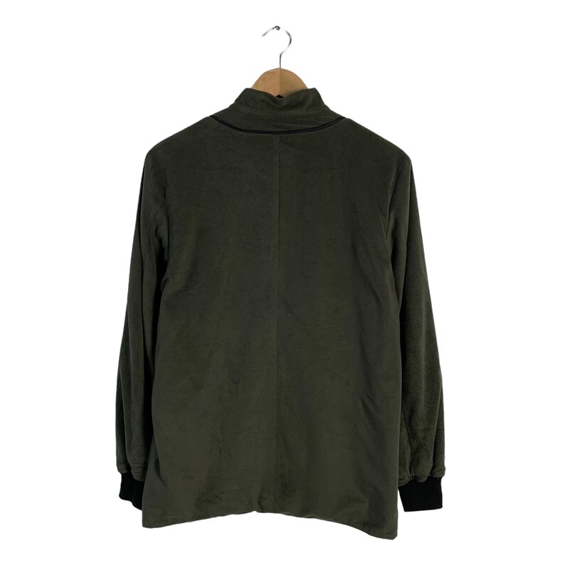 May include: A dark green long-sleeved shirt with a mock neck and black trim around the neck and cuffs.