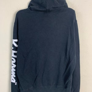 May include: Black hooded sweatshirt with white "Panama" text on the left sleeve.