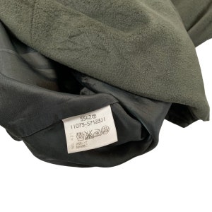 May include: A black and green garment tag with the text "5542 11073-57123J1" and care instructions in Japanese.