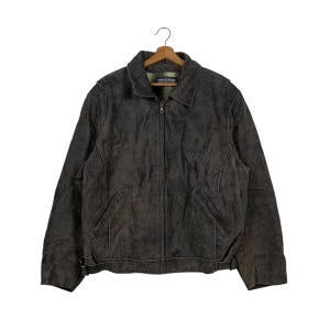 May include: A brown leather jacket with a zipper closure and two pockets. The jacket has a  "Weatherproof Leather" label on the collar.