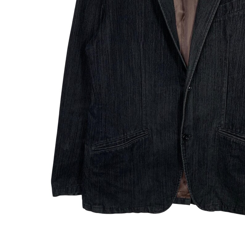 May include: A black corduroy blazer with a single button closure and two front pockets.