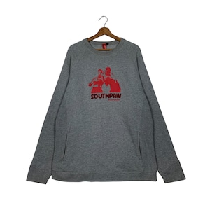 May include: A gray sweatshirt with a red graphic of two boxers and the text "Southpaw" in red. The sweatshirt has a pocket on the left side.