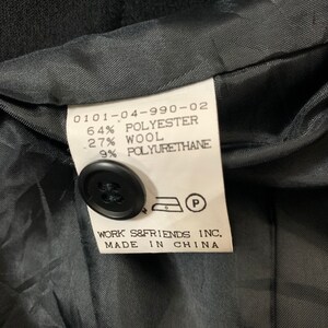 May include: Black fabric label with white text that reads "0101-04-990-02 64% Polyester 27% Wool 9% Polyurethane" and "WORK S&FRIENDS INC. MADE IN CHINA".