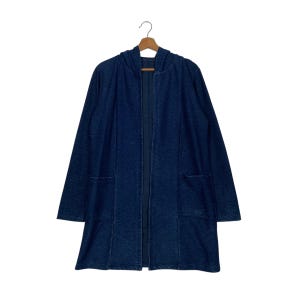 May include: A long, dark blue denim cardigan with a hood and pockets. The cardigan is open in the front and has a zipper closure.