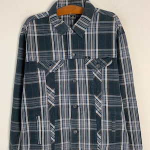 May include: A black and white plaid long-sleeved button-up shirt jacket with a dark brown collar and cuffs.