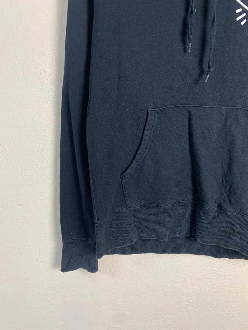 May include: Black hooded sweatshirt with a kangaroo pocket and a drawstring hood.