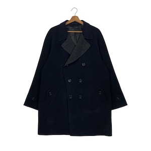 May include: A dark blue double-breasted wool coat with a contrasting grey collar and pockets.