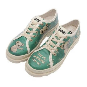 May include: A pair of green canvas low-top sneakers with white laces and a white rubber sole. The sneakers feature a print of koalas and the text "Take me wherever you go".