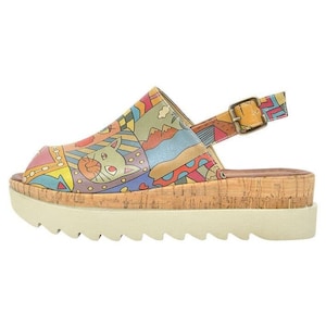 May include: Multicolored platform sandals with a cork wedge sole and an adjustable ankle strap. The sandals feature a whimsical print with a cat, geometric shapes, and a mountain scene.
