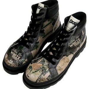May include: A pair of black high-top boots with a white and green print. The print features a whimsical illustration of a rabbit and the text "Follow the White Rabbit".