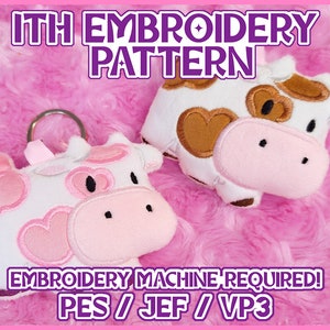 May include: Two plush cow keyrings with pink and brown details, set against a pink, fluffy background. The text "ITH EMBROIDERY PATTERN" and "EMBROIDERY MACHINE REQUIRED!" are visible. The keyrings are white with pink heart and brown patches.