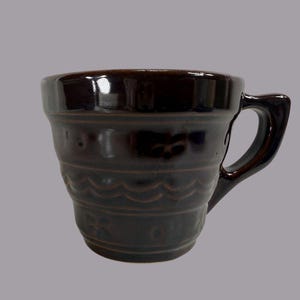 May include: A rustic wooden sign with the text "Welcome to our home" in white lettering. The sign features a distressed finish and a simple, inviting design, perfect for entryway decor.