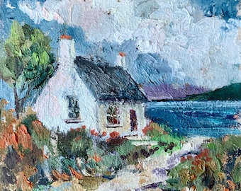 May include: Oil painting of a white cottage with a dark roof, set against a backdrop of a blue sea and cloudy sky. The cottage has two windows and a red door, surrounded by colorful foliage. A tree stands to the left.