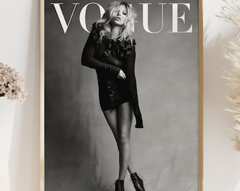 May include: A black and white photo of a woman wearing a black dress and boots. The photo is framed and the word "VOGUE" is printed in white at the top of the photo.