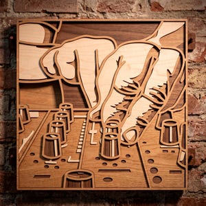 May include: A square multi-layered wooden wall art piece featuring a laser-cut design of a DJ mixing console. The artwork uses contrasting light and dark wood tones to depict knobs, faders, and a hand adjusting the equipment in a relief style.