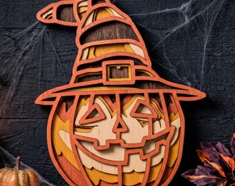 May include: A layered wooden wall hanging shaped like a jack-o'-lantern wearing a witch hat. The design features stacked cutouts in shades of orange, yellow, and dark brown, creating a dimensional effect with a carved face and a hat buckle.