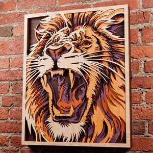 May include: A multi-layered wooden wall art piece featuring a roaring lion. The design uses stacked laser-cut wood panels in shades of natural light wood, warm orange, and deep purple to create a three-dimensional effect within a rectangular frame.