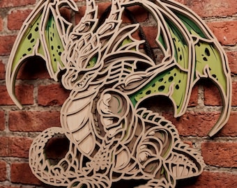 May include: A multi-layered wooden wall art piece featuring a detailed dragon design. The artwork is constructed from stacked laser-cut wood panels in natural light brown tones, with vibrant green accents visible in the wings and body segments.
