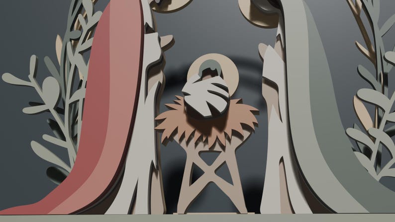 May include: A layered paper-cut style nativity scene featuring stylized figures of two adults in muted pink and sage green robes standing on either side of a central infant figure resting in a manger, all framed by decorative foliage elements.