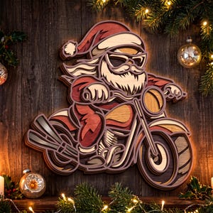May include: A multi-layered wooden wall art piece depicting Santa Claus wearing sunglasses and riding a motorcycle. The design features shades of red, natural wood, and dark brown, with intricate cutouts creating a three-dimensional effect.