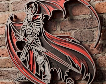May include: A multi-layered wall art piece featuring a knight in horned armor holding a sword. The design uses shades of red, black, and light gray to create depth. The figure is depicted with a flowing cape and wings, constructed from stacked materials to form a three-dimensional silhouette.