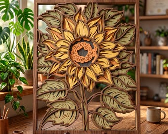 May include: A layered wooden sunflower art piece. The sunflower has yellow, orange, and brown petals, with green leaves and a brown stem. The artwork is set in a wooden frame and displayed on a wooden stand.