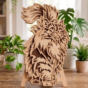 May include: A wooden cat sculpture with a layered design. The cat is depicted in a sitting position with a fluffy tail and fur. The sculpture is made of light brown wood and stands on a wooden easel.