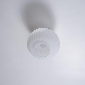 May include: White frosted glass ceiling light fixture with a ribbed design.