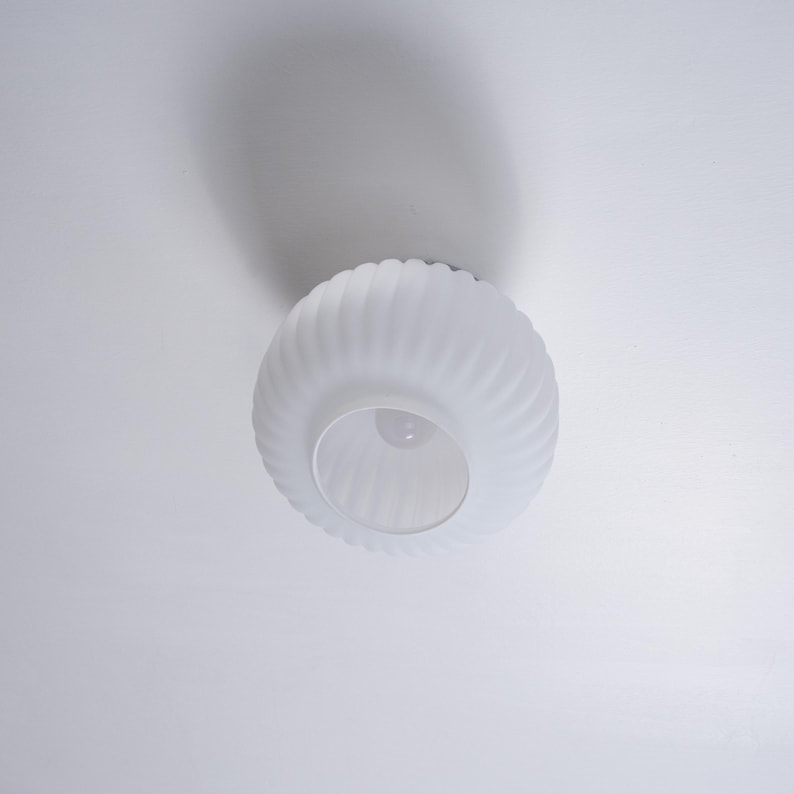 May include: White frosted glass ceiling light fixture with a ribbed design.