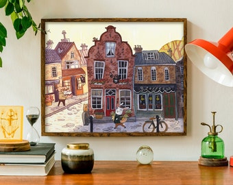 May include: A watercolor painting of a street scene with brick buildings, a cafe called "Coffee", and a rabbit carrying a basket of flowers. The painting is framed in a brown wood frame.