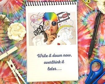 Puede incluir: Una libreta blanca de espiral con un collage colorido en la portada. El collage incluye imágenes de una mujer, un arcoíris, una cámara y las palabras "You Tube Yo" y "VIDEO". La libreta tiene el texto "Write it down now, overthink it later..." impreso en la portada.