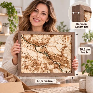 May include: A rectangular wooden framed map of Bremen, Germany, featuring intricate laser-cut details of the city streets and the Weser river. The frame is 6.0 cm deep, and the map measures 40.5 cm wide by 30.5 cm high, including a small crest.