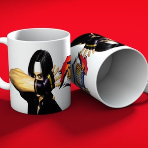 May include: White ceramic mug featuring a character illustration with black hair, a white headband, and black gloves. The character is in a fighting stance, with the text "FIGHT" visible. The mug is on a red surface.