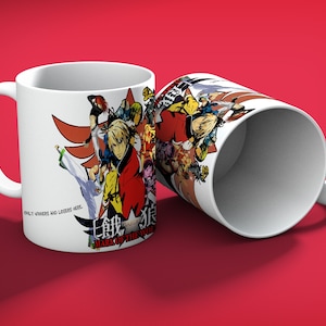 May include: White ceramic mug featuring a colorful anime-style illustration with the text "MARK OF THE WOLVES" and "ONLY WINNERS AND LOSERS HERE." The design includes various characters in action poses. The mug is set against a red background.