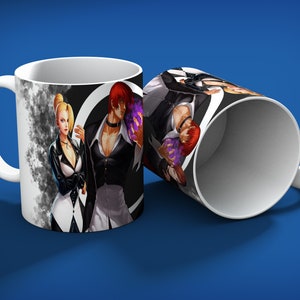 May include: White ceramic mug featuring a colorful illustration of anime characters. The design includes a man with red hair and a woman with blonde hair, set against a black and white background. The mug is displayed on a blue surface.