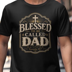 May include: Black t-shirt with a vintage design. The design includes the words "BLESSED TO BE CALLED DAD" in a decorative frame, a cross, and the text "Proverbs 20:7".