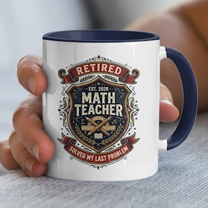 May include: White ceramic mug with a navy blue handle and interior. The mug features a detailed graphic with the words "Retired Math Teacher" and "Solved My Last Problem". The design includes mathematical symbols and the year 2026.
