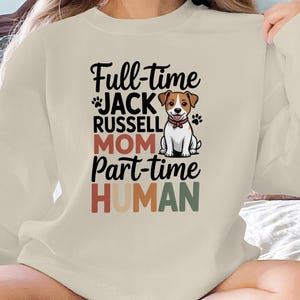 May include: Cream-colored sweatshirt with the text "Full-time Jack Russell Mom Part-time Human" in black, red, and green. A cartoon Jack Russell Terrier is centered above the word "Mom".