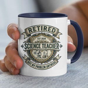 May include: White ceramic mug with a navy blue interior and handle. The mug features the words "Retired Science Teacher" in a vintage design, along with the text "Est 2026" and "Not My Problem Anymore". A microscope and beakers are also shown.