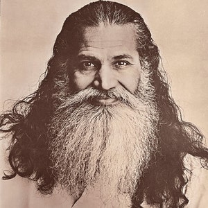 May include: A black and white photo of a man with long, dark hair and a long, white beard. The man is smiling and looking at the camera. The text on the poster reads "Yoga is over four thousand years old. But it may be new to you." and "Swami Satchidananda at the Village Theater. Friday, Sept. 8 at 8 p.m. A birthday celebration of Sri Swami Sivananda, Himalayas."