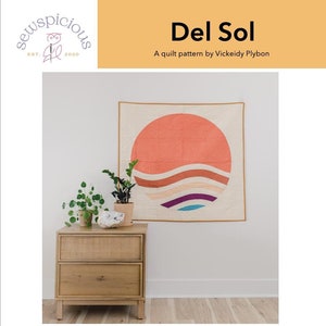 May include: A quilt pattern called "Del Sol" by Vickeidy Plybon. The pattern is for a baby or wall hanging quilt that is 40 inches by 40 inches. The quilt features a sunset design with a large orange circle and wavy lines in shades of blue, purple, and brown. The pattern is labelled as intermediate skill level.