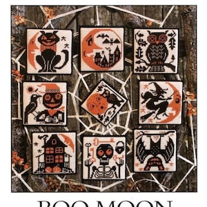 May include: A cross-stitch pattern book titled "Boo Moon" by The Prairie Schooler. The cover features various Halloween-themed cross-stitch designs, including a black cat, owl, witch, and skeleton, all in orange and black. The book's title and publisher are displayed at the top.