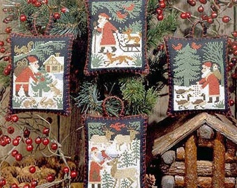 May include: Four handmade Christmas ornaments with a winter theme. Each ornament features a different scene with a red and white color scheme. The ornaments are made of fabric and have a stitched border.