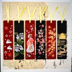 May include: Set of seven colorful bookmarks with various designs, including flowers, birds, and a Japanese-style building. The bookmarks are made of a sturdy material and have a ribbon attached to the top.