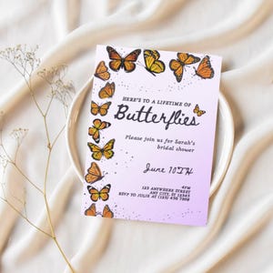 May include: A bridal shower invitation with a lavender gradient background. The invitation features orange and yellow butterflies and the text "Here's to a Lifetime of Butterflies." The date is June 10th.