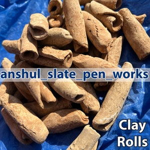 May include: A collection of light brown clay rolls with a textured finish. The image features the text "anshul_slate_pen_works" and "Clay Rolls" in white. The clay rolls are displayed on a blue surface.