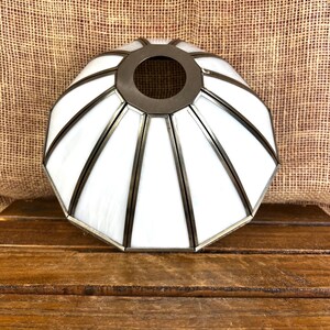 May include: A dome-shaped lamp shade constructed from twelve individual panels of opaque white glass. Each glass panel is framed by dark metallic soldering, creating a segmented geometric pattern that converges at a circular opening at the top.