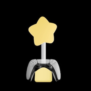 May include: A yellow star-shaped lamp is mounted on a white pole, above a grey and black game controller. A yellow rectangular light is below the controller. The background is black.