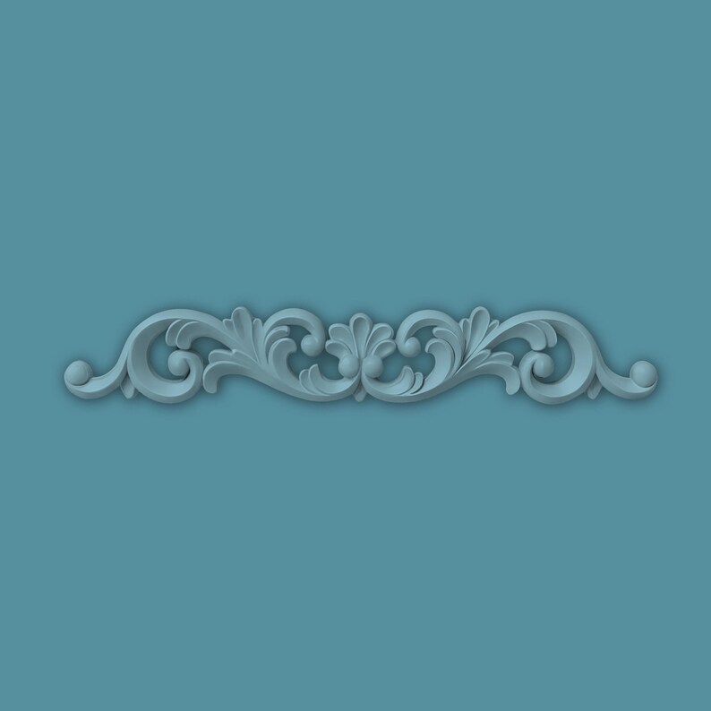 May include: A light blue, symmetrical scrollwork design with an ornate, stylized floral and leaf pattern. The design is centered against a teal background. The scrollwork features rounded edges and a three-dimensional effect.