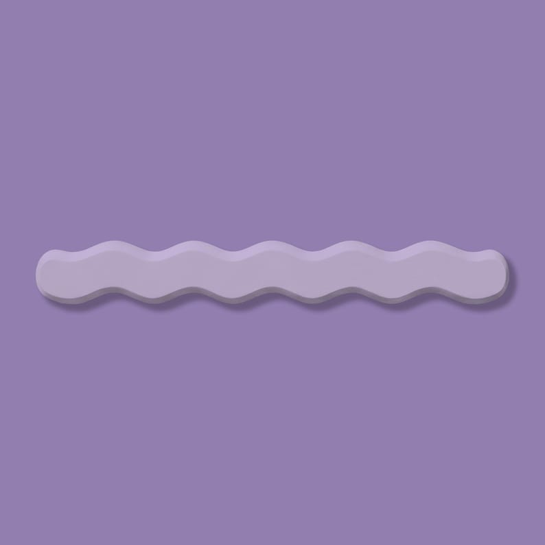 May include: A light purple, wavy-edged decorative object against a matching purple background. The object has a smooth, matte finish and casts a subtle shadow, creating a three-dimensional effect. The design is simple and modern.